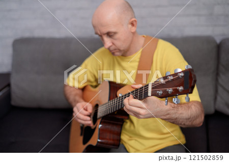 Guitarist on acoustic guitar playing melody in studio. Close up musician instrument Guitarist on acoustic guitar playing melody in studio. Close up musician instrument 121502859