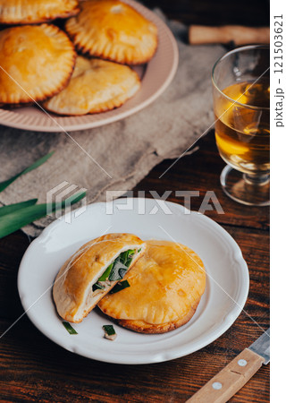Oven Baked Pastries with Blue Chives and Mushrooms and Glass of Wine 121503621