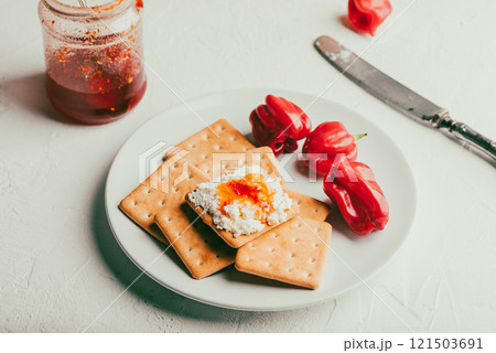 Cracker with cream cheese and chili pepper jam 121503691