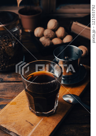 Glass of coffee brewed in traditional vietnamese drip filter Glass of coffee brewed in traditional vietnamese drip filter 121503792