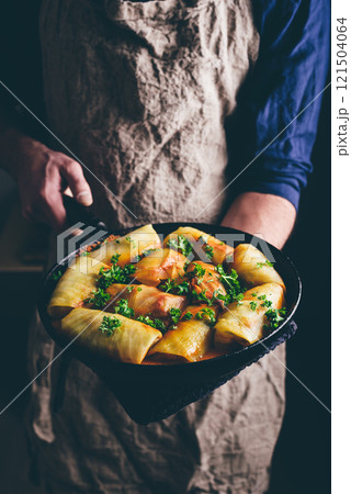 Man Hands with Pan Full of Cooked Cabbage Rolls Man Hands with Pan Full of Cooked Cabbage Rolls 121504064