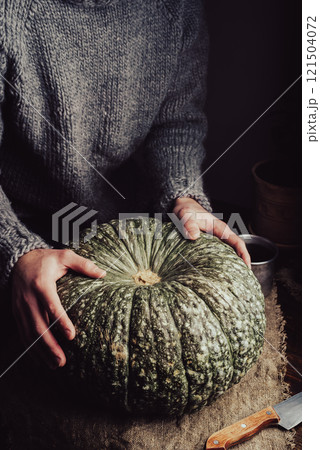 Big Green Pumpkin on Rustic Table 121504072