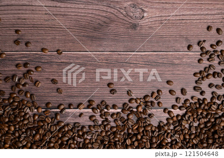Top view roasted coffee beans on wooden table. Copy space background, cover, backdrop, texture. Place for adding text or design Top view roasted coffee beans on wooden table. Copy space background, cover, backdrop, texture. Place for adding text or design 121504648