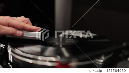 Man cleaning retro vinyl with special brush - turntable vinyl record player. Man cleaning retro vinyl with special brush - turntable vinyl record player. 121504980