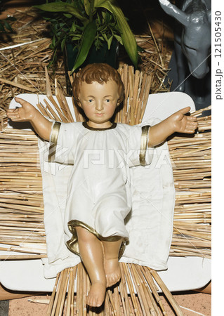 Baby Jesus laying in a cradle 121505430
