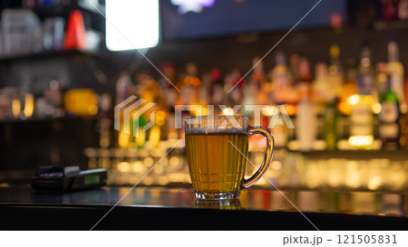 A mug of beer on the bar counter in a pub. 121505831