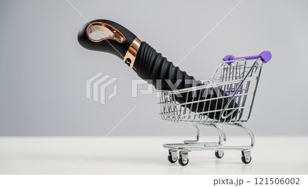 Sex toy in miniature shopping cart on white background.  121506002