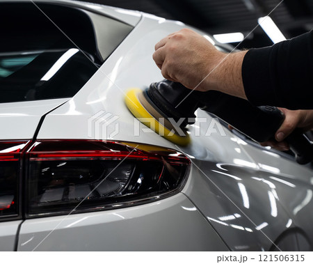 Process of polishing white car body surface using orbital polishing machine.  121506315