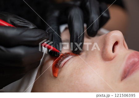 Caucasian woman undergoing eyelash lamination procedure. Caucasian woman undergoing eyelash lamination procedure. 121506395