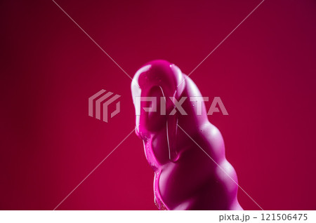 Lube pouring on pink dildo on pink background. Lube pouring on pink dildo on pink background. 121506475