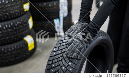 Mechanic keeps new studded car tires in garage.  121506537