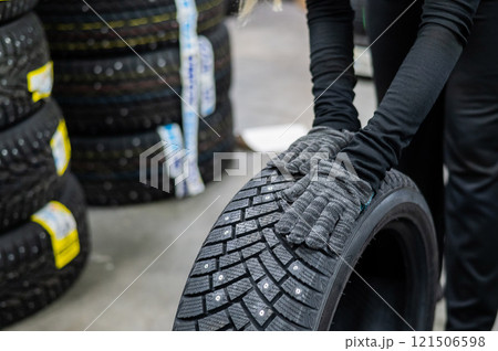 Mechanic keeps new studded car tires in garage. Mechanic keeps new studded car tires in garage. 121506598