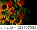 Colorful arrangement of sunflowers and dahlias with green leave on a 121507082