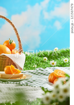 Frontal shot of two bottle mockups displayed on a blue picnic rug, next to an apple basket and some picnic utensils. A picnic concept on a green meadow with some daisy flowers in a blue sky. Frontal shot of two bottle mockups displayed on a blue picnic rug, next to an apple basket and some picnic utensils. A picnic concept on a green meadow with some daisy flowers in a blue sky. 121507479