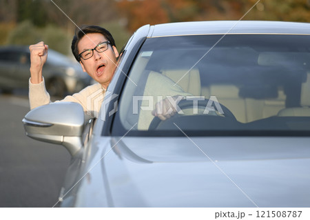運転しながらイライラする中年男性 121508787