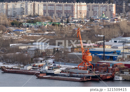 Orange loading crane on the river pier. 121509415