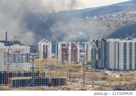 Black smoke from a fire in the city. Black smoke from a fire in the city. 121509420