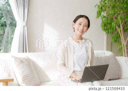 ソファでパソコン作業をする女性 121509433