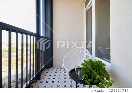 A Stylish Balcony Featuring Contemporary Decor Alongside Beautiful Greenery and Plants 121511715