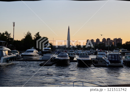 Boats Docked at Sunset with the Stunning City Skyline in the Background for a Beautiful View 121511742