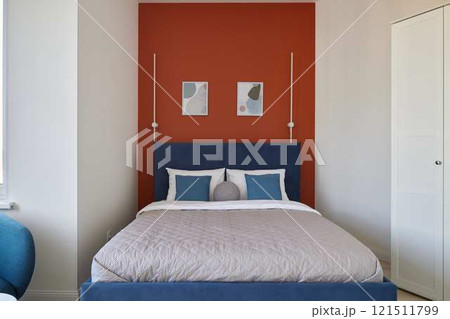 A stylish bedroom interior with colorful accents, creating an inviting and comfortable ambiance 121511799