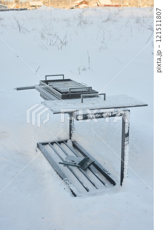 A Lovely SnowCovered Grill Set Against a Beautiful and Charming Winter Landscape Scene A Lovely SnowCovered Grill Set Against a Beautiful and Charming Winter Landscape Scene 121511807