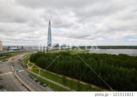 The modern city skyline boasts innovative futuristic architecture alongside a lush green landscape 121511821