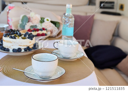 An Elegant Afternoon Tea Setup on a Luxurious Yacht with Delectable and Tasty Desserts to Enjoy An Elegant Afternoon Tea Setup on a Luxurious Yacht with Delectable and Tasty Desserts to Enjoy 121511835