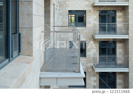 A Sleek and Modern Apartment Balcony Featuring Elegant Glass Railings for Safety and Style 121511988