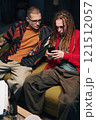 Guys Using Smartphone At Party 121512057