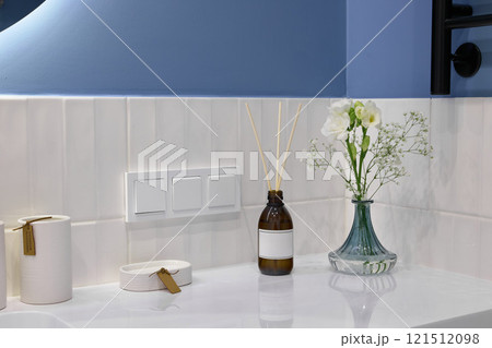 An Elegant Bathroom Countertop adorned with Decor elements that evoke Serenity and calmness An Elegant Bathroom Countertop adorned with Decor elements that evoke Serenity and calmness 121512098