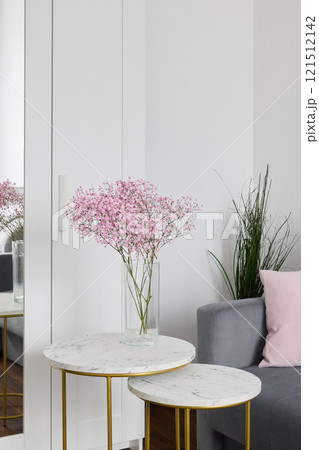 Stylish Living Room Decor Featuring Beautiful Pink Flowers and Elegant Tables for a Cozy Ambiance 121512142