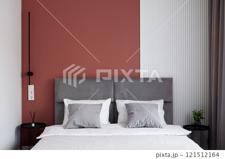 Experience a Stylish and Modern Bedroom featuring a Beautiful TwoToned Accent Wall 121512164