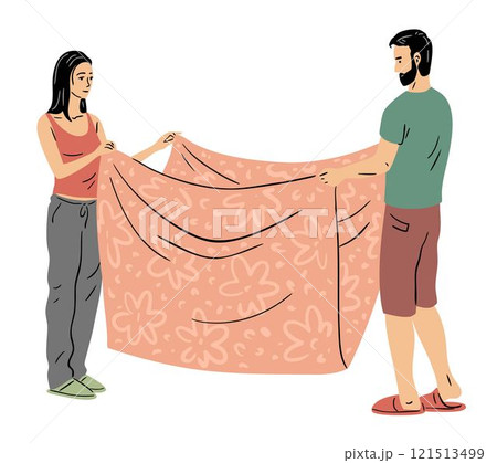 A young couple is laying out their linen and blanket 121513499