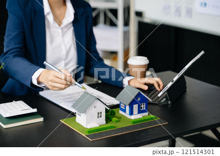 real estate agent worker working with laptop and tablet at table in office real estate agent worker working with laptop and tablet at table in office 121514301