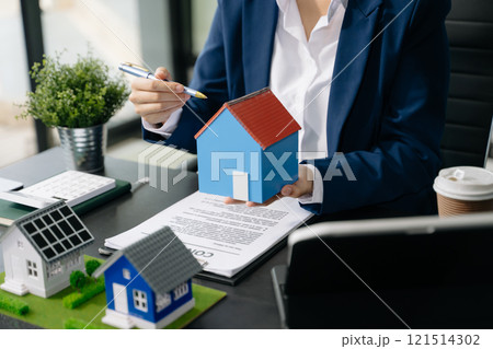 Real estate broker agent presenting and consult to customer to decision making sign insurance form agreement, home model, 121514302