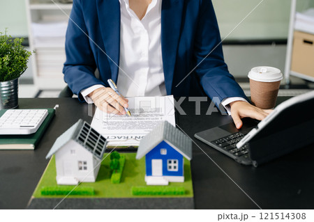 Real estate broker agent presenting and consult to customer to decision making sign insurance form agreement, home model, 121514308