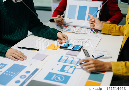 Close up view of UI developer team brainstorming on their project with laptop, smartphone and digital tablet. Close up view of UI developer team brainstorming on their project with laptop, smartphone and digital tablet. 121514468