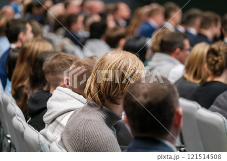 Audience attending a conference or event seated in a lecture room 121514508