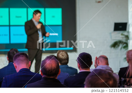 Business conference audience listens to speaker during professional presentation 121514552