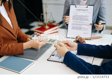 Lawyer refusing bribe money in the envelop from business man at lawyer office. 121514753