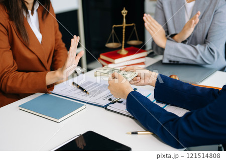 justice and law concept.passing bribe money in the envelop at lawyer office. businessman hand taking bribe money from female 121514808