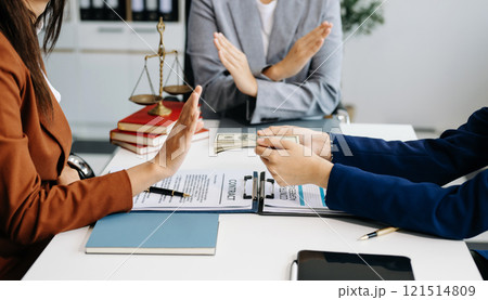 justice and law concept.passing bribe money in the envelop at lawyer office. businessman hand taking bribe money from female 121514809