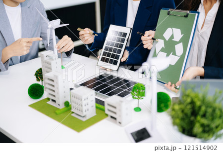Business people having consultation about wind energy at company office. Business team discussing about windmill and alternative green enery. Executive meeting 121514902