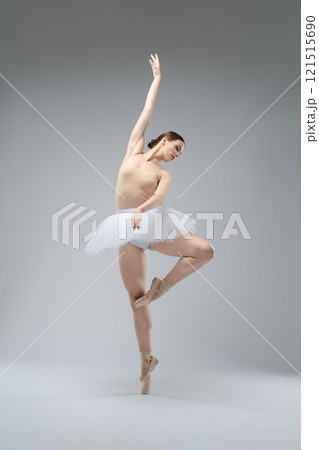 Ballerina performing an elegant pose in a minimalist studio setting Ballerina performing an elegant pose in a minimalist studio setting 121515690