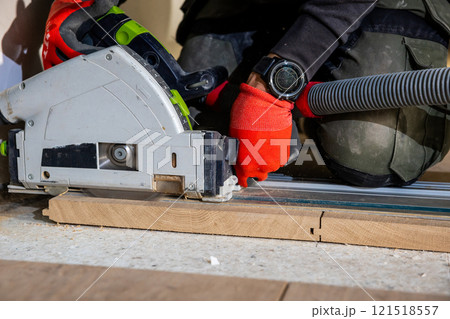 Carpenter Using Circular Saw with Dust Extraction System Carpenter Using Circular Saw with Dust Extraction System 121518557