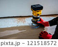 Carpenter Using Yellow and Black Router on Wooden Surface 121518572