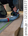 Person Using Track Saw with Vacuum Hose in Indoor Construction Setting 121518577