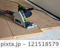Circular Saw on Wooden Floorboards in Construction Setting 121518579