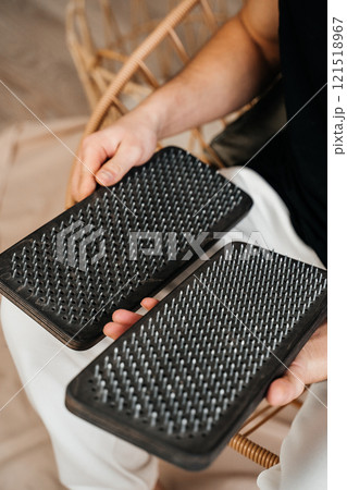 A man holds a Sadhu Board in his hands. Close-up. The concept of a healthy lifestyle. 121518967